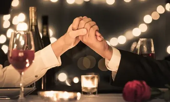 holding hands at a romantic dinner